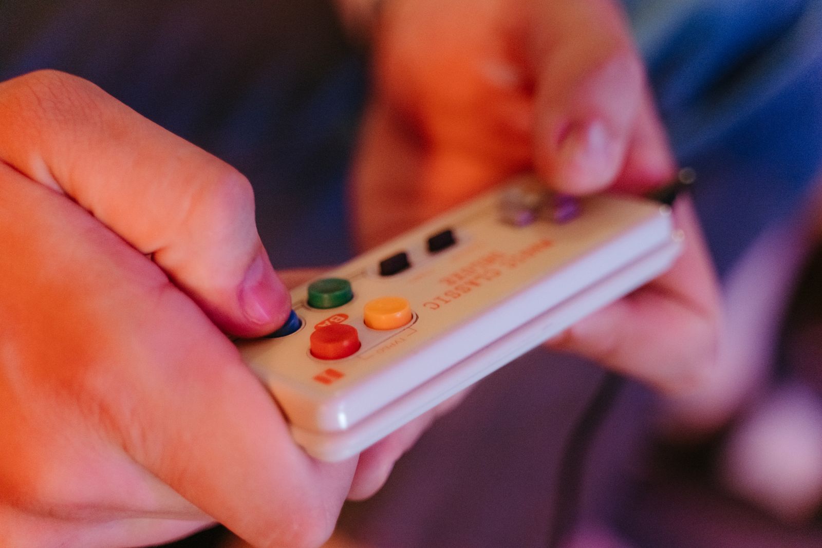 Hands holding a retro game controller